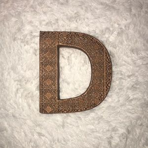 Gold decorative “D”